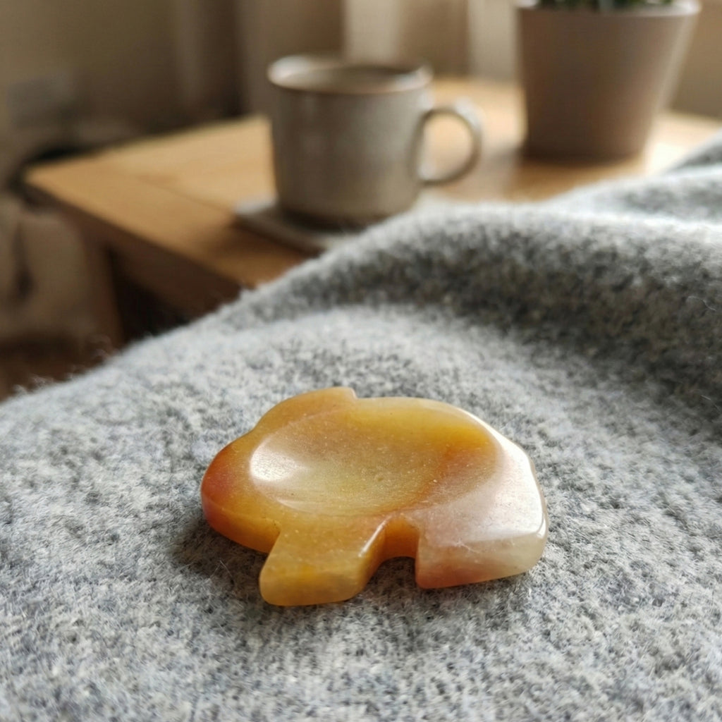 Lumi - Rabbit shaped crystal worry stone in Yellow Jade lay flat