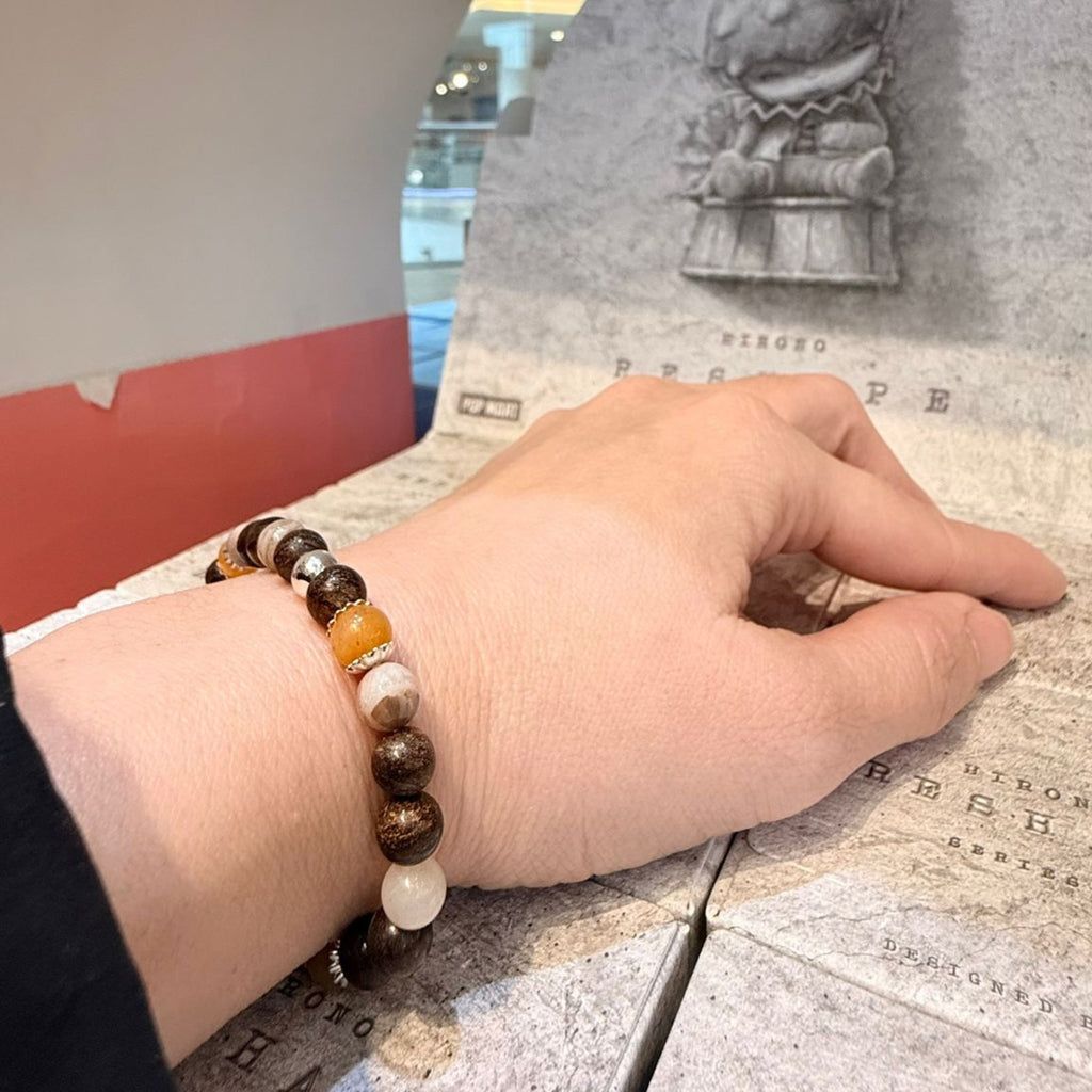 MARCEL Prosper Bracelet – Bronzite, Yellow Jade & Bamboo Leaf Agate with a lady worn on her wrist inside a shop