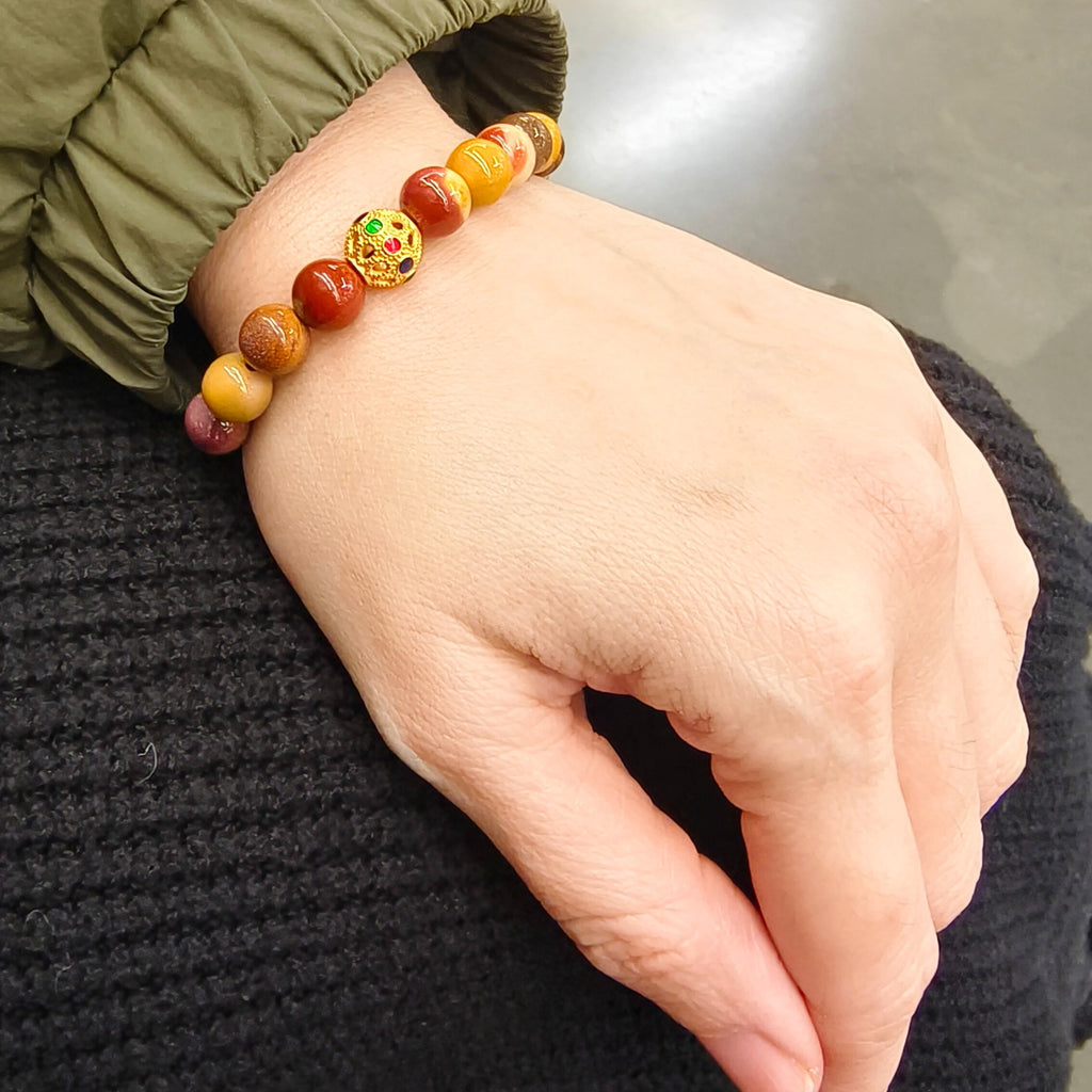 MIRA Health Bracelet – Mookaite worn on wrist in a shopping center